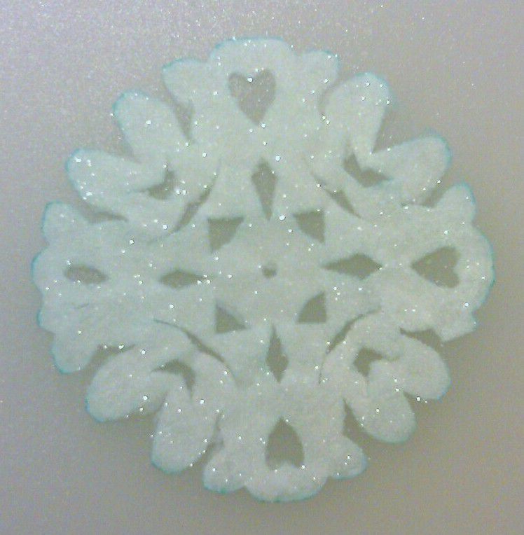 Cover a paper snowflake with crystals to make a glittering crystal snowflake ornament.