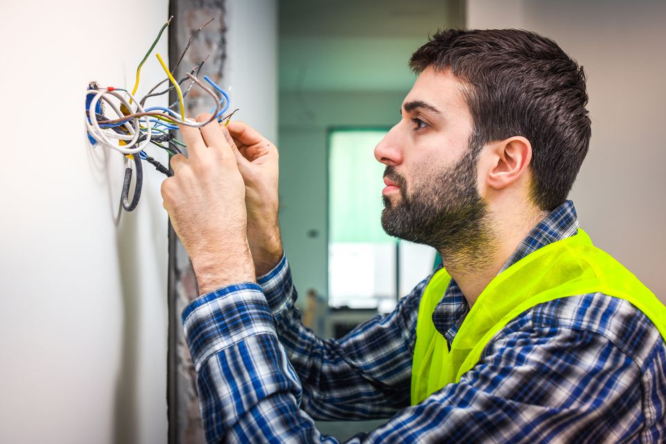 Electricianfixingwires-GettyImages-697067556-59a7083a9abed50011fd6600.jpg