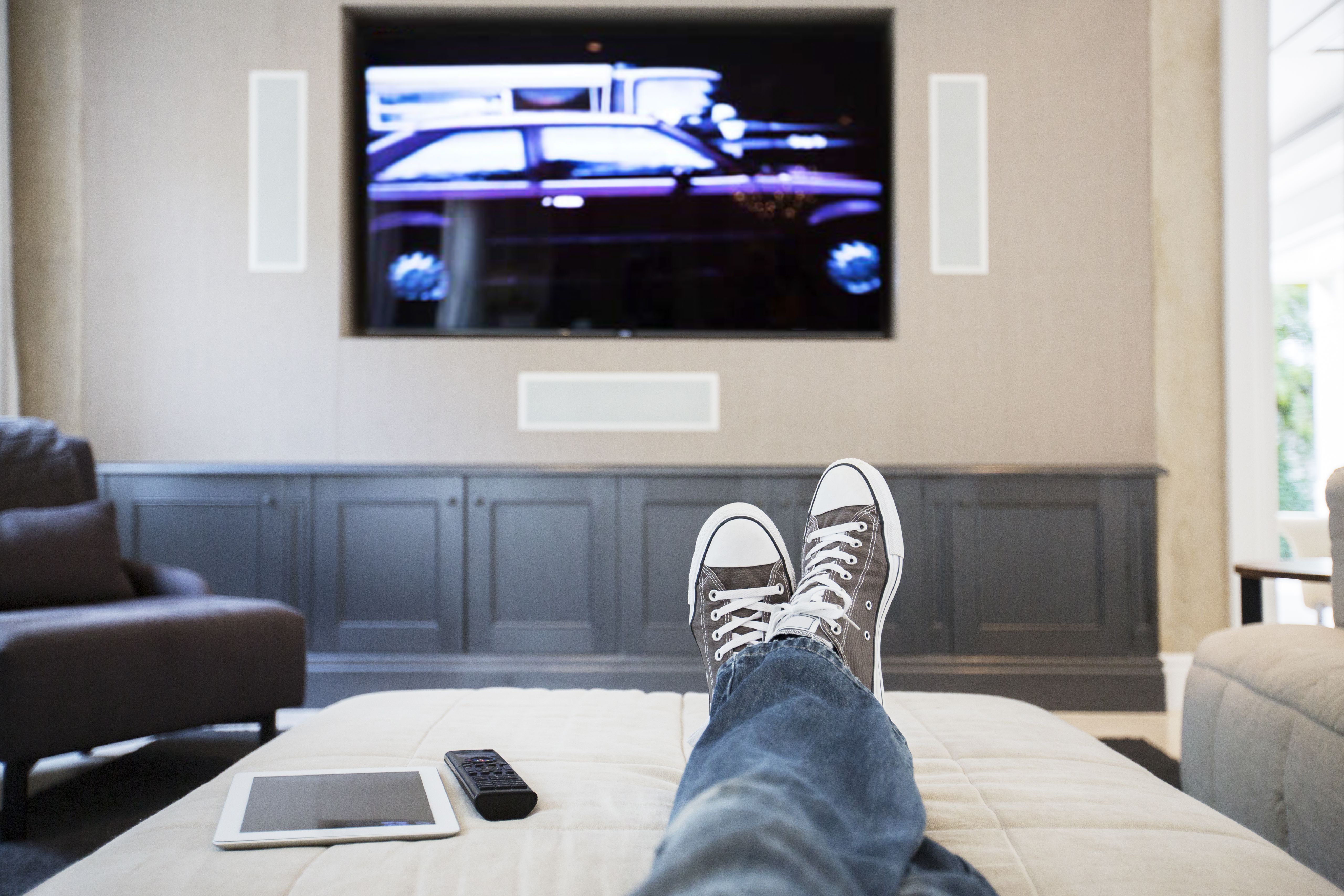 womans feet on ottoman watching tv 568518443 57eee2ad3df78c690f30d50c