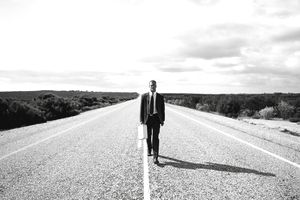 Businessman on a desert highway