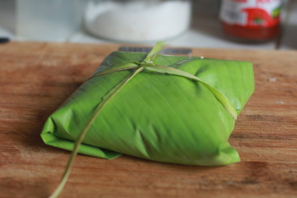 Tying banana leaf-wrapped food