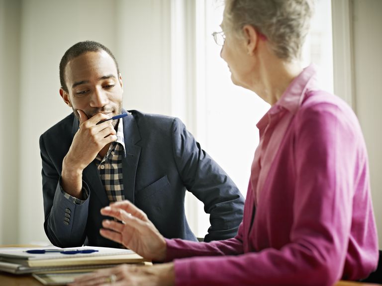 Coworkers in discussion at conference room table