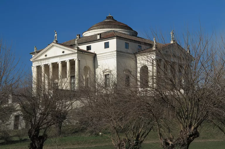 stone villa on a rural hill, square with four porticos on each side, center dome, symmetrical