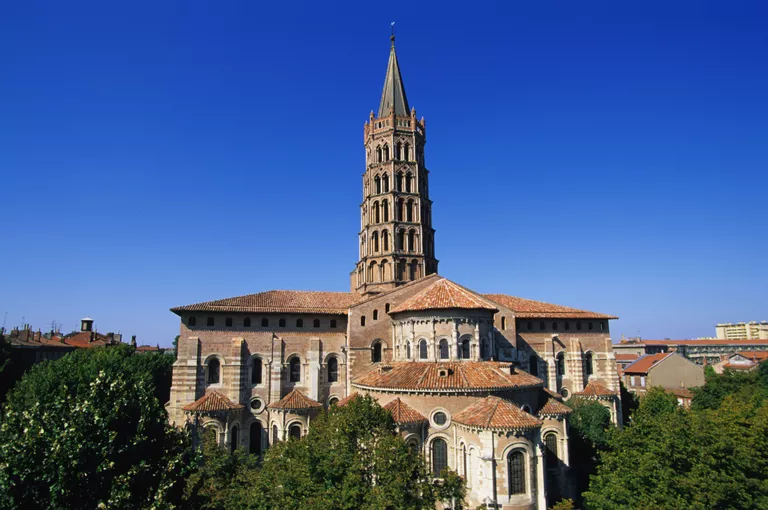Rounded arches, massive walls, tower of the Basilica of St. Sernin (1070-1120) in Toulouse, France