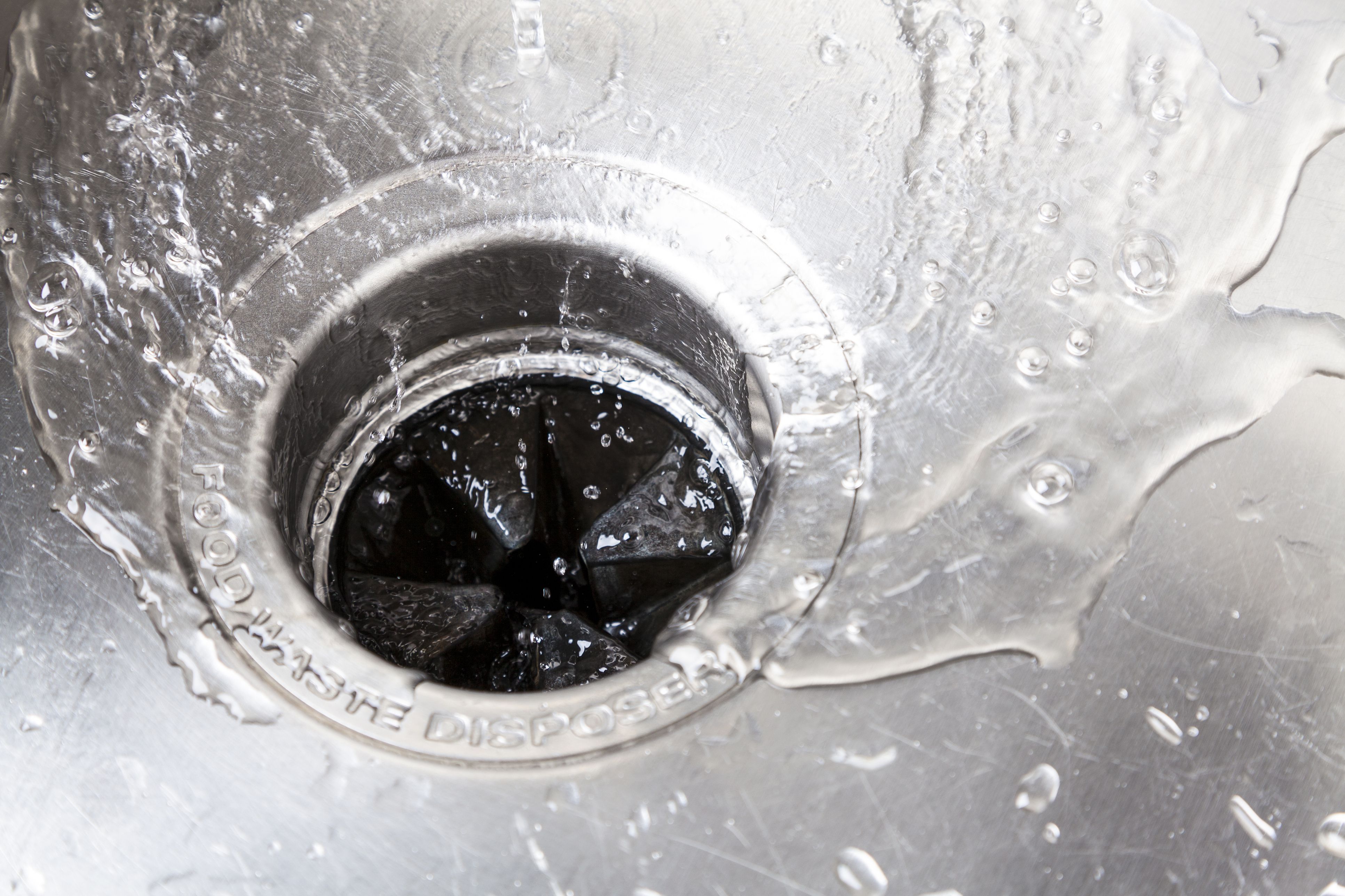 water building up in kitchen sink with garbage disposal