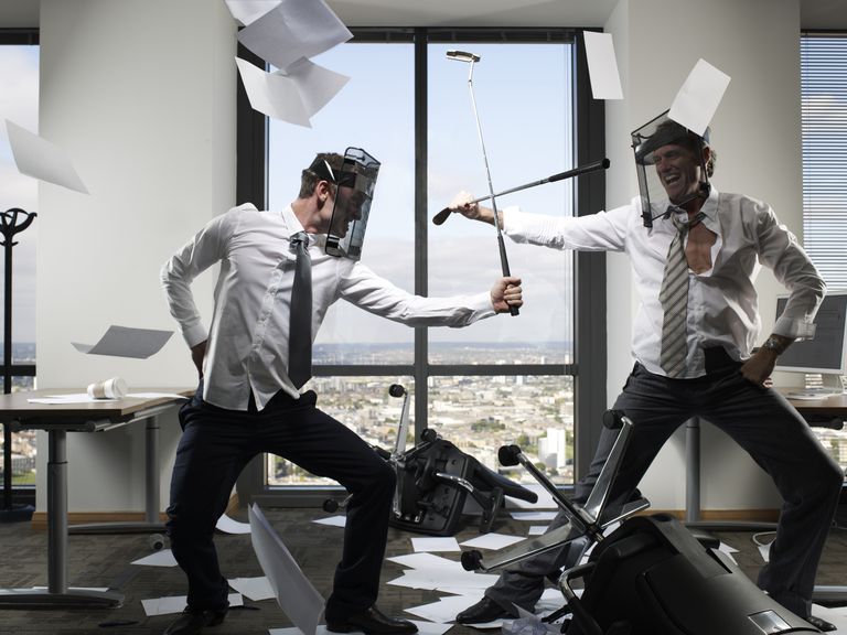 Businessmen fighting with golf clubs