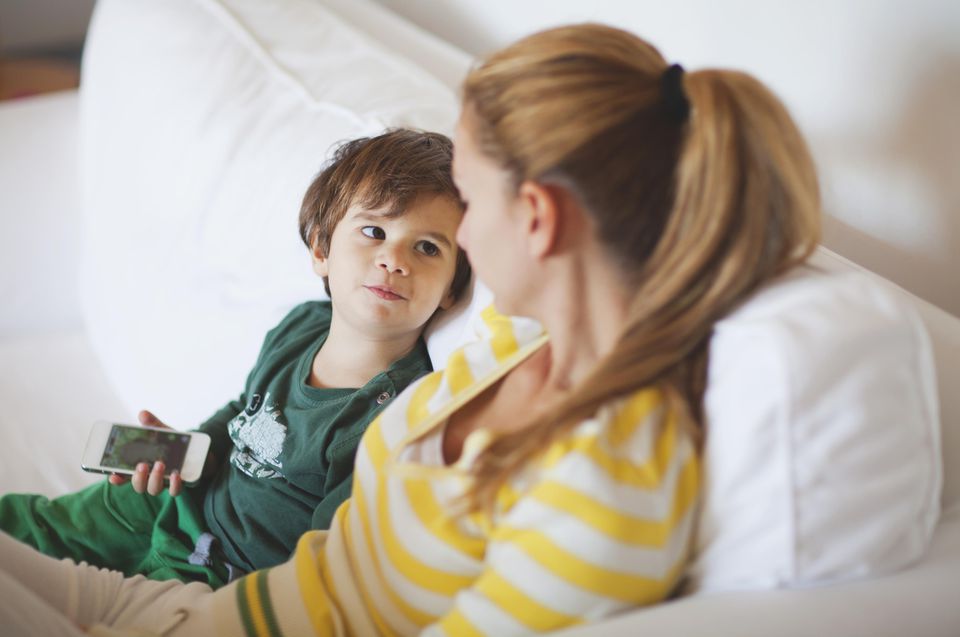 Small boy talking to his mother