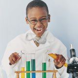 A picture of a child playing with test tubes