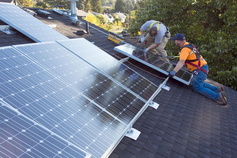 Men installing panels on roof
