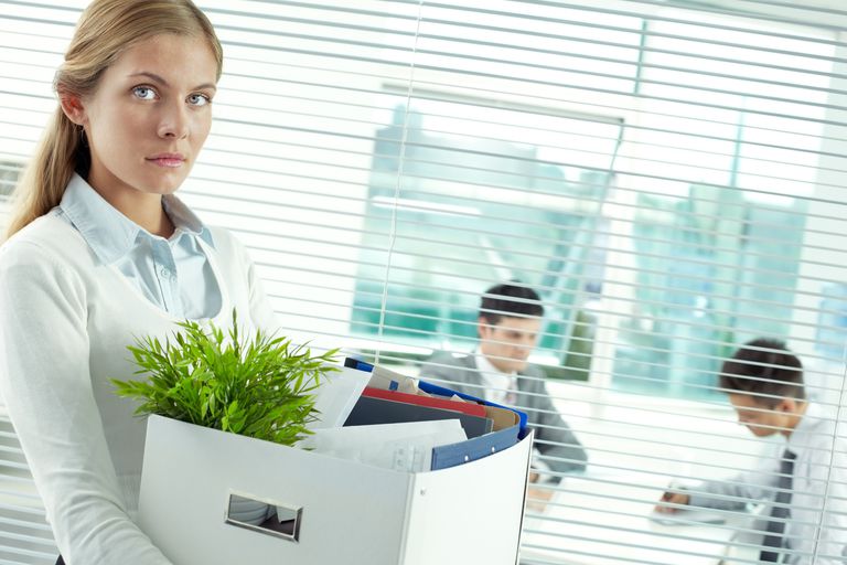 Woman Removes Personal Effects From Her Office