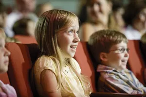 A photo of a girl and boy at a movie theater.