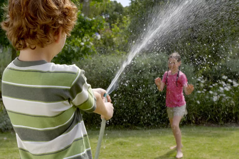 boy and girl with hose